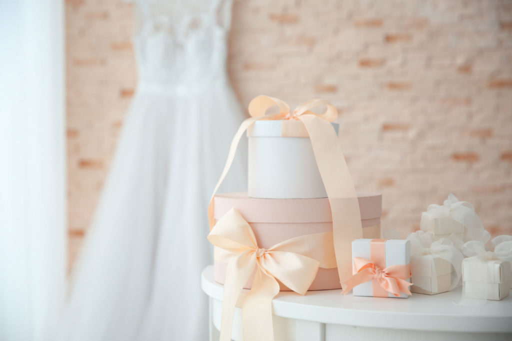 Stacked pastel wedding gift boxes with ribbons