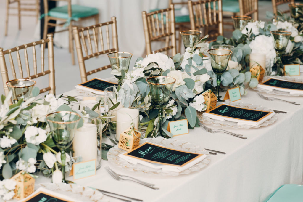 Elegant wedding table with greenery and menus