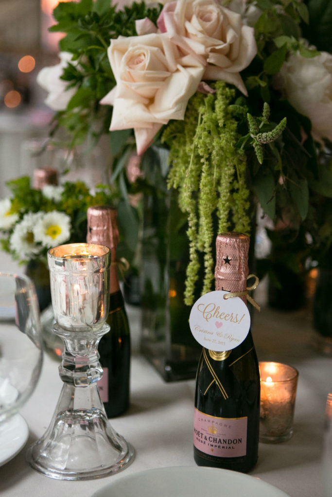 Mini champagne bottles with roses and candles